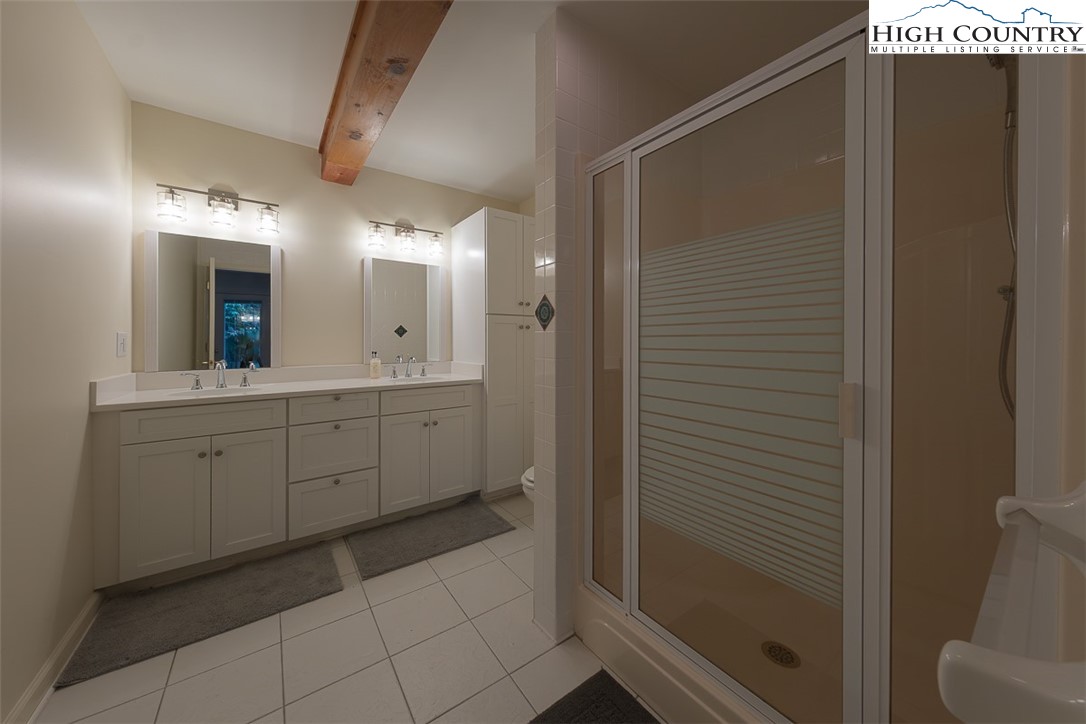 148 Chestnut Ridge Lane Glade Valley, NC 28627 - Photo 41 of 50 a spacious bathroom with a mirror and a shower