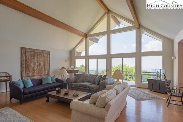 a view of a livingroom with furniture and a window