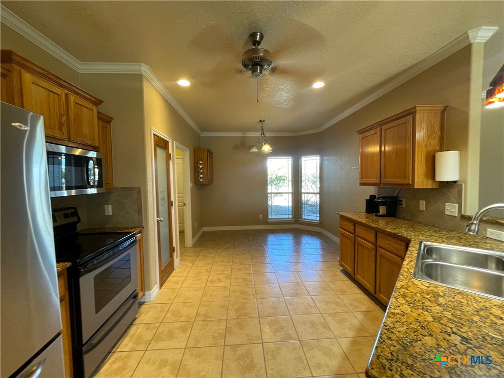 170 County Road 4709 Kempner, TX 76539 - Photo 5 of 24 a large kitchen with a stove a refrigerator and a sink