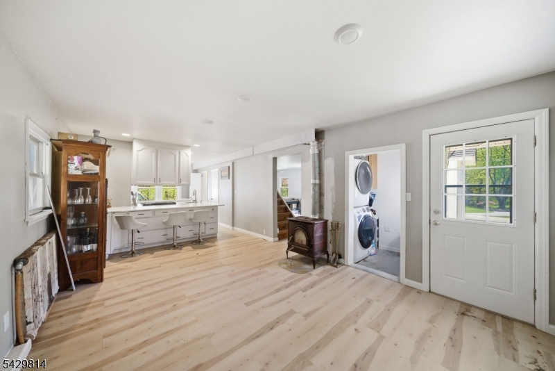 251 Russia Road Oak Ridge, NJ 07438 - Photo 6 of 34 a view of a living room kitchen and a wooden floor