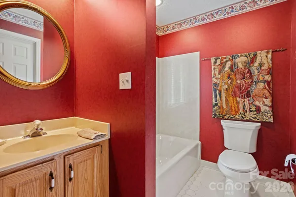 a bathroom with a sink a toilet and shower curtain