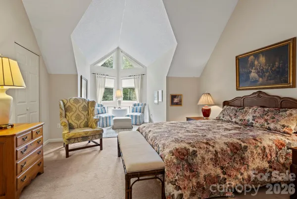 a bedroom with a bed and glass windows