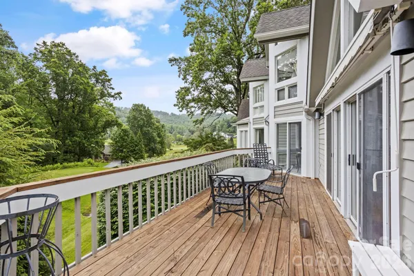 a view of balcony with furniture and wooden floor