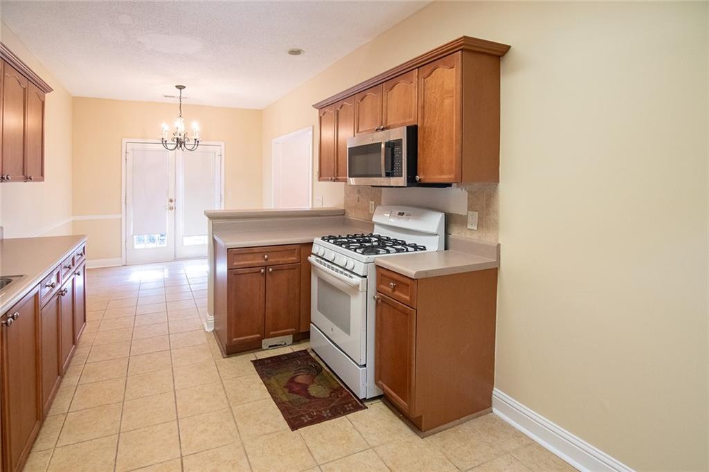 2545 Rosehill Circle Lithia Springs, GA 30122 - Photo 12 of 27 a kitchen with stainless steel appliances a stove top oven and cabinets