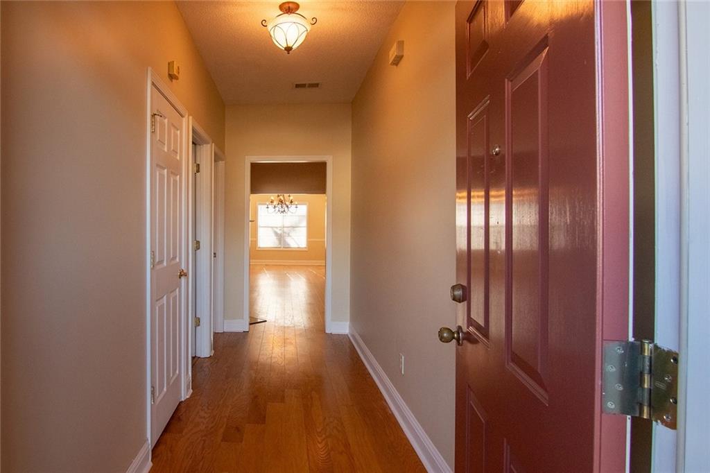 2545 Rosehill Circle Lithia Springs, GA 30122 - Photo 3 of 27 a view of a hallway with wooden floor and staircase