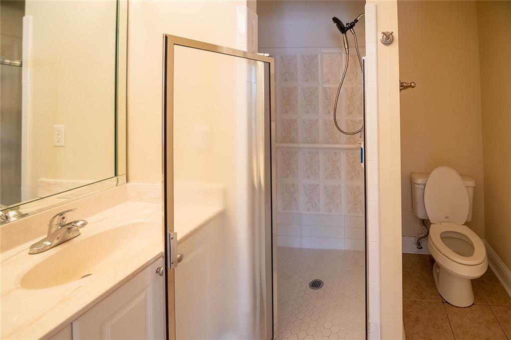 2545 Rosehill Circle Lithia Springs, GA 30122 - Photo 5 of 27 a bathroom with a granite countertop sink toilet and shower