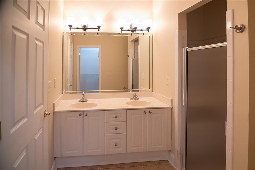 2545 Rosehill Circle Lithia Springs, GA 30122 - Photo 6 of 27 a bathroom with a double vanity sink and a mirror
