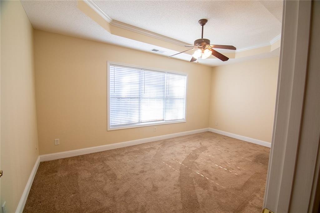 2545 Rosehill Circle Lithia Springs, GA 30122 - Photo 10 of 27 an empty room with windows and fan