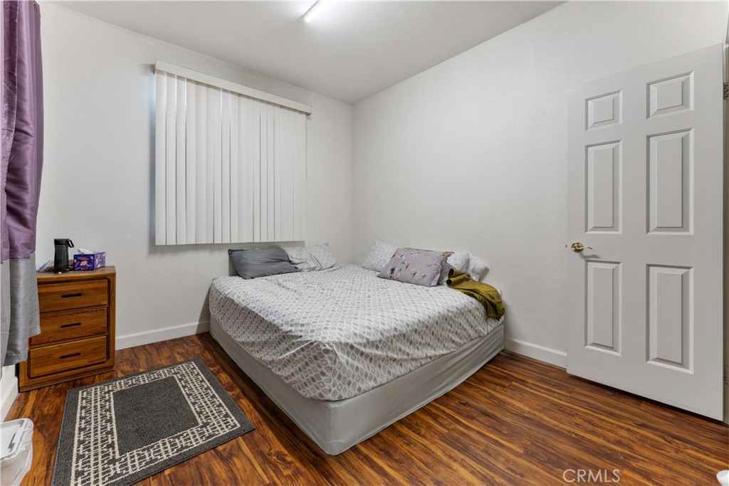 11390 Parkfield Court Riverside, CA 92505 - Photo 16 of 42 a bed sitting in a bedroom next to a window