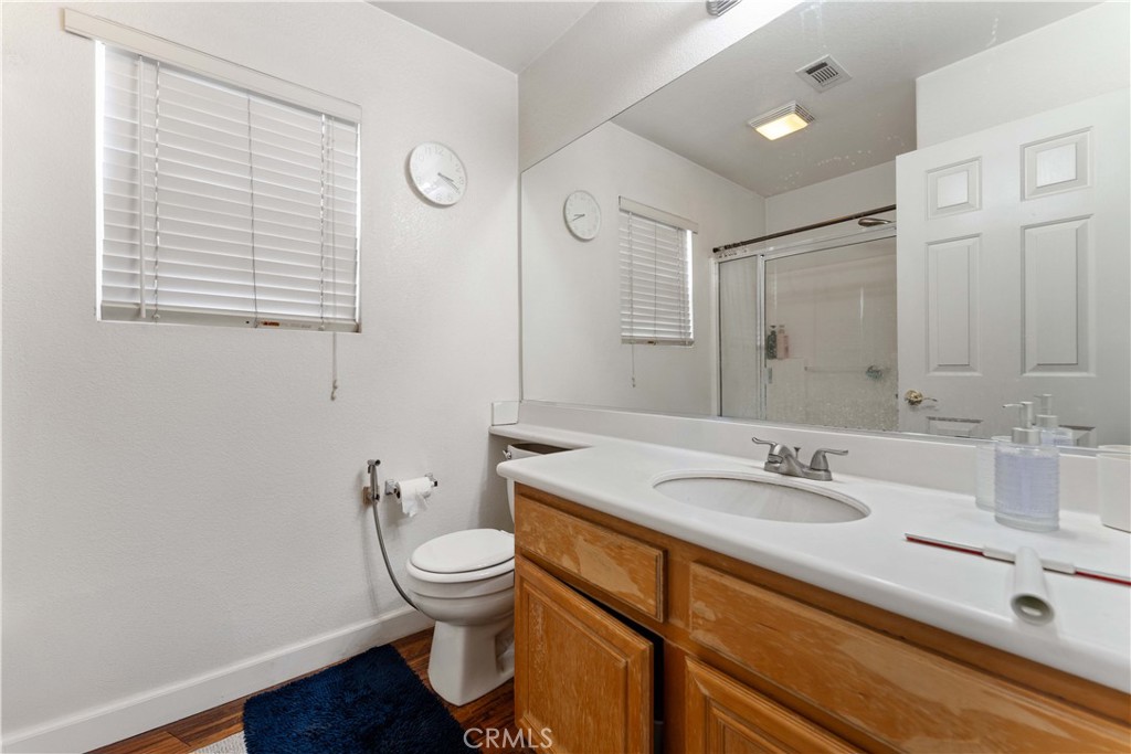11390 Parkfield Court Riverside, CA 92505 - Photo 18 of 42 a bathroom with a sink a toilet and a mirror