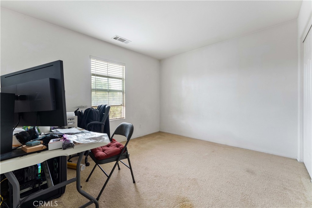 11390 Parkfield Court Riverside, CA 92505 - Photo 22 of 42 a workspace with furniture and a flat screen tv