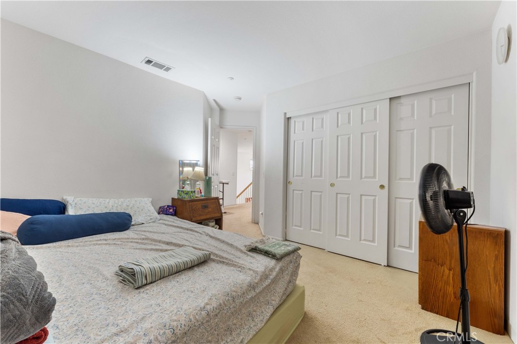 11390 Parkfield Court Riverside, CA 92505 - Photo 27 of 42 a bedroom with a bed and dresser