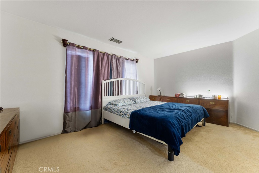 11390 Parkfield Court Riverside, CA 92505 - Photo 28 of 42 a bedroom with a bed and a dresser