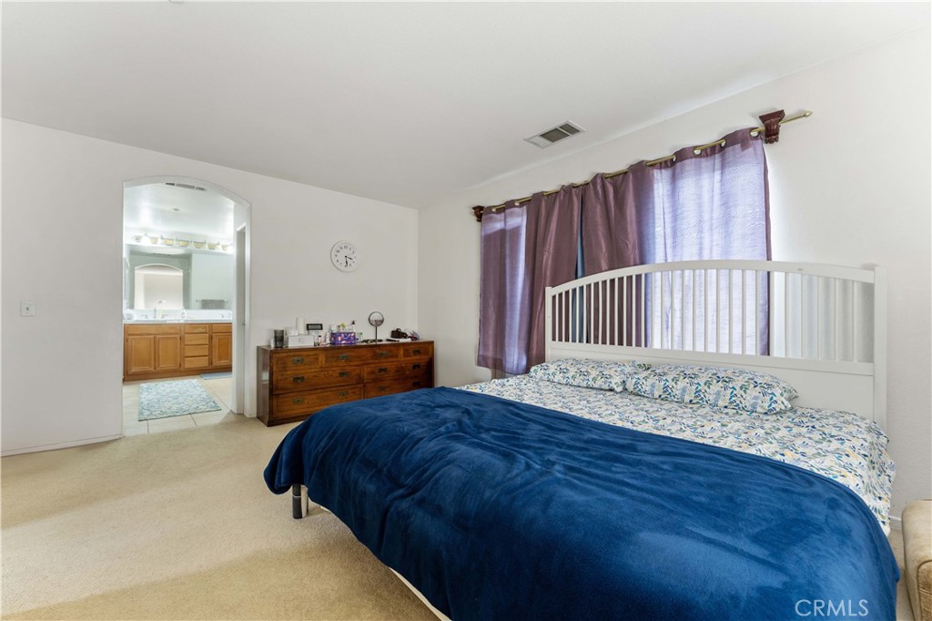 11390 Parkfield Court Riverside, CA 92505 - Photo 29 of 42 a bed room with a bed and a television
