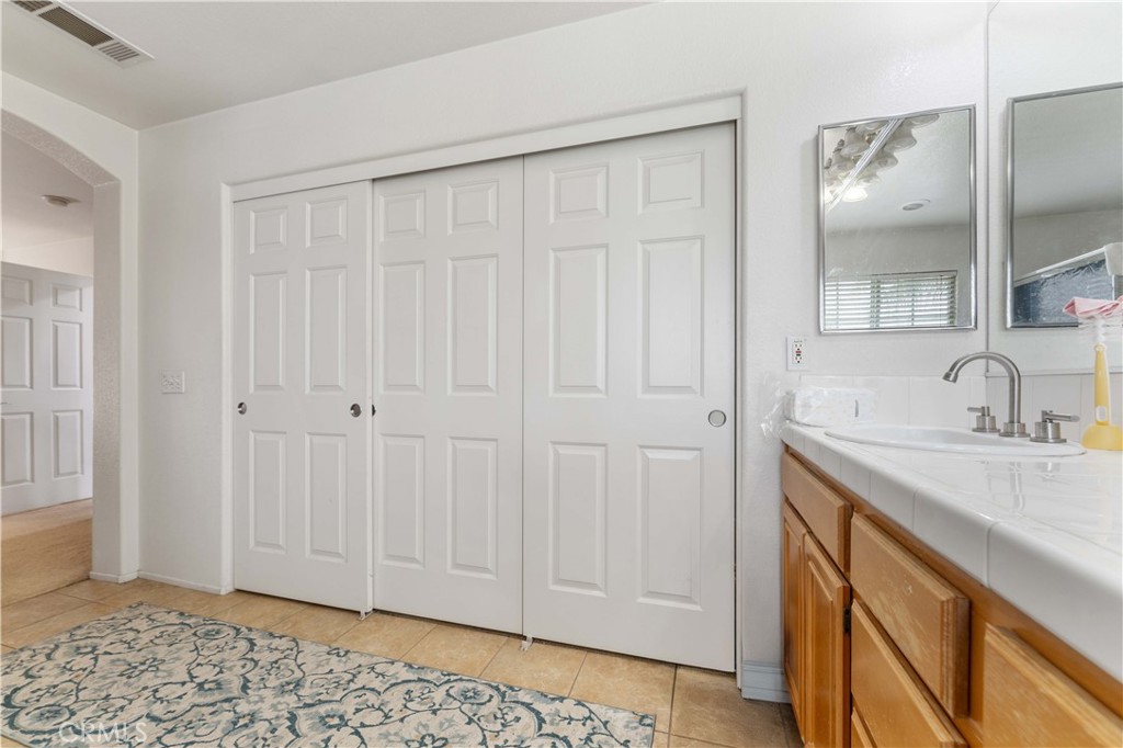 11390 Parkfield Court Riverside, CA 92505 - Photo 31 of 42 a bathroom with a sink and a mirror