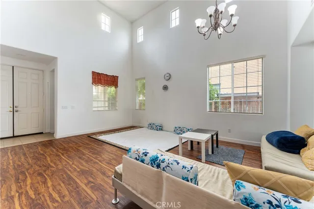 a living room with furniture chandelier and window