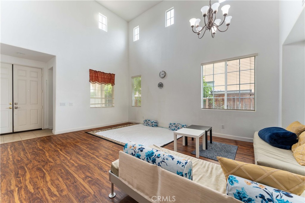 11390 Parkfield Court Riverside, CA 92505 - Photo 7 of 42 a living room with furniture chandelier and window