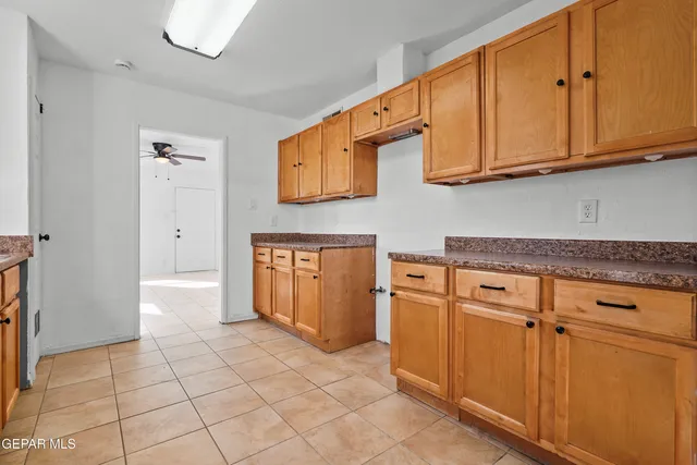 a kitchen with stainless steel appliances granite countertop a refrigerator and cabinets