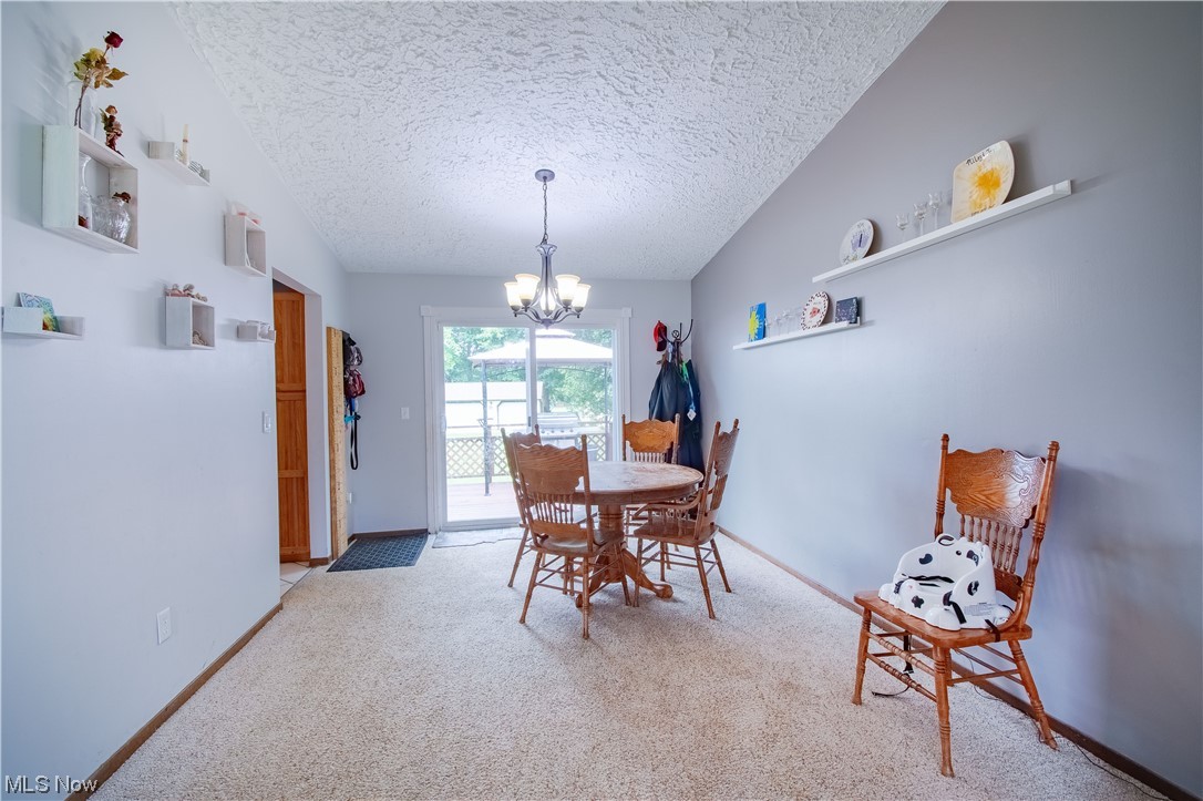 241 Ridge Road Mogadore, OH 44260 - Photo 11 of 26 the dining area featuring sliding glass doors to the oversized deck