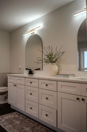 a bathroom with a double vanity sink and a mirror
