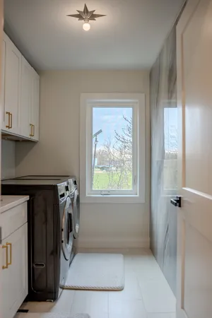 an entryway with a washer and dryer