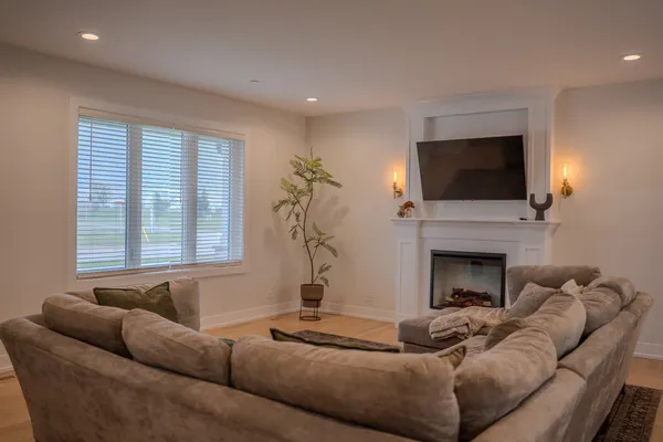 a living room with furniture a fireplace and a flat screen tv