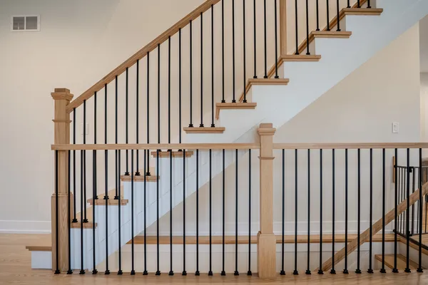 a view of staircase with railing and white walls