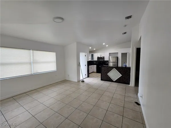 a view of a livingroom with furniture an entryway
