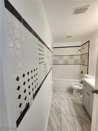 a bathroom with a bathtub and a toilet