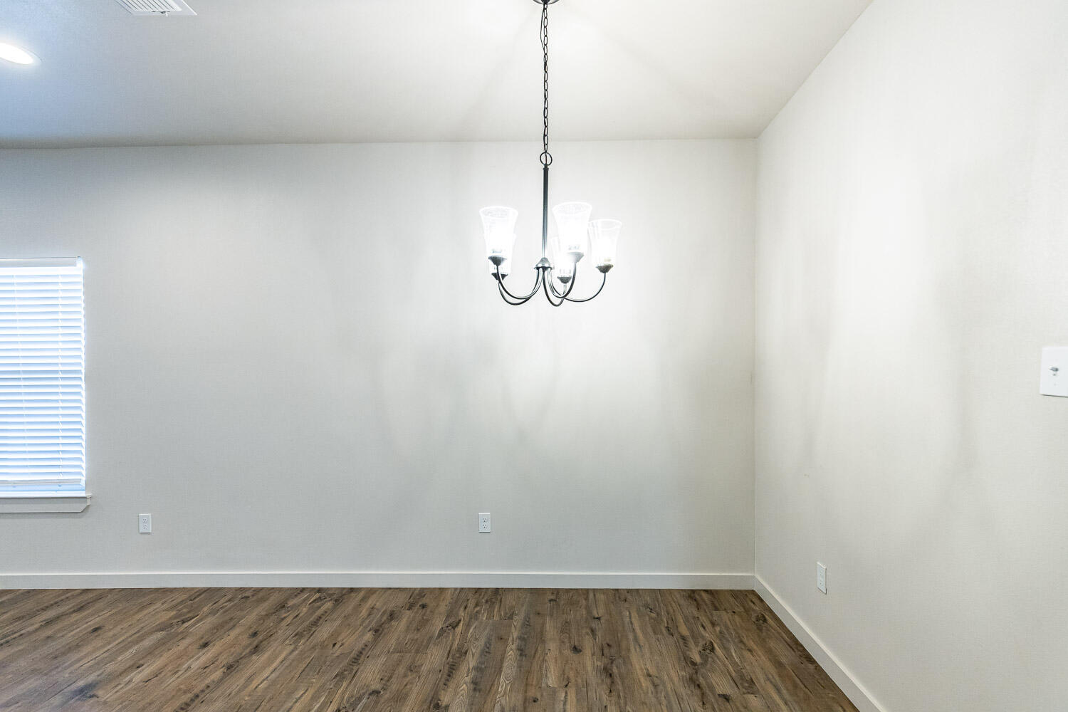 5527 121st Street, Unit A Lubbock, TX 79404 - Photo 12 of 56 a view of a room with wooden floor and white walls
