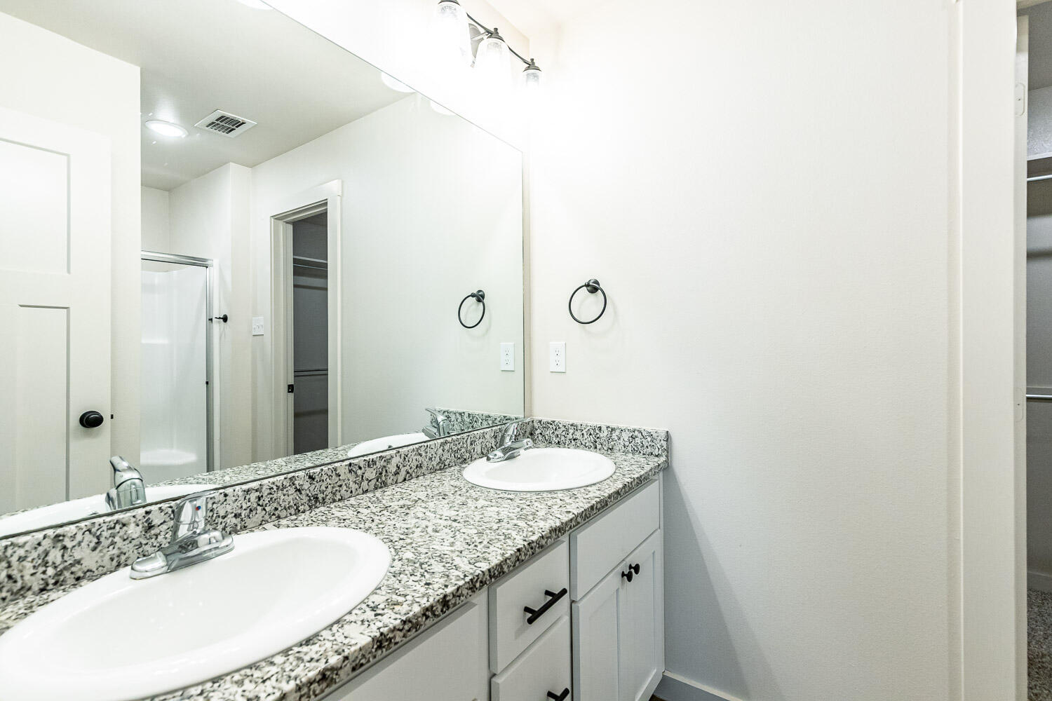 5527 121st Street, Unit A Lubbock, TX 79404 - Photo 27 of 56 a bathroom with a granite countertop sink and a mirror
