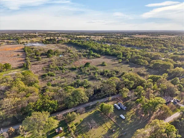 a view of a field with an ocean view