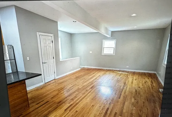 a view of a room with wooden floor and staircase