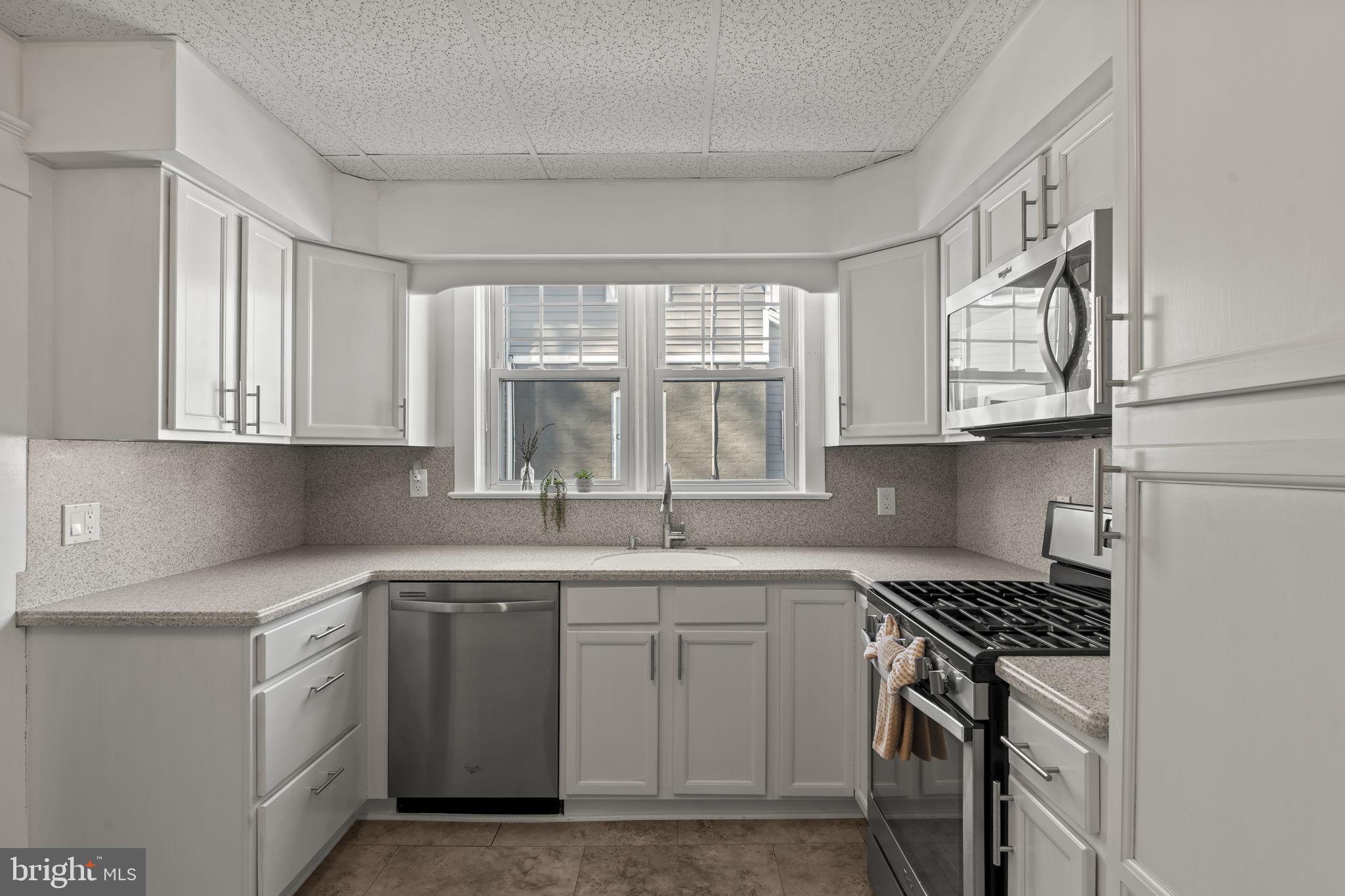 237 7th Avenue Haddon Heights, NJ 08035 - Photo 11 of 35 a kitchen with cabinets appliances a sink and a window