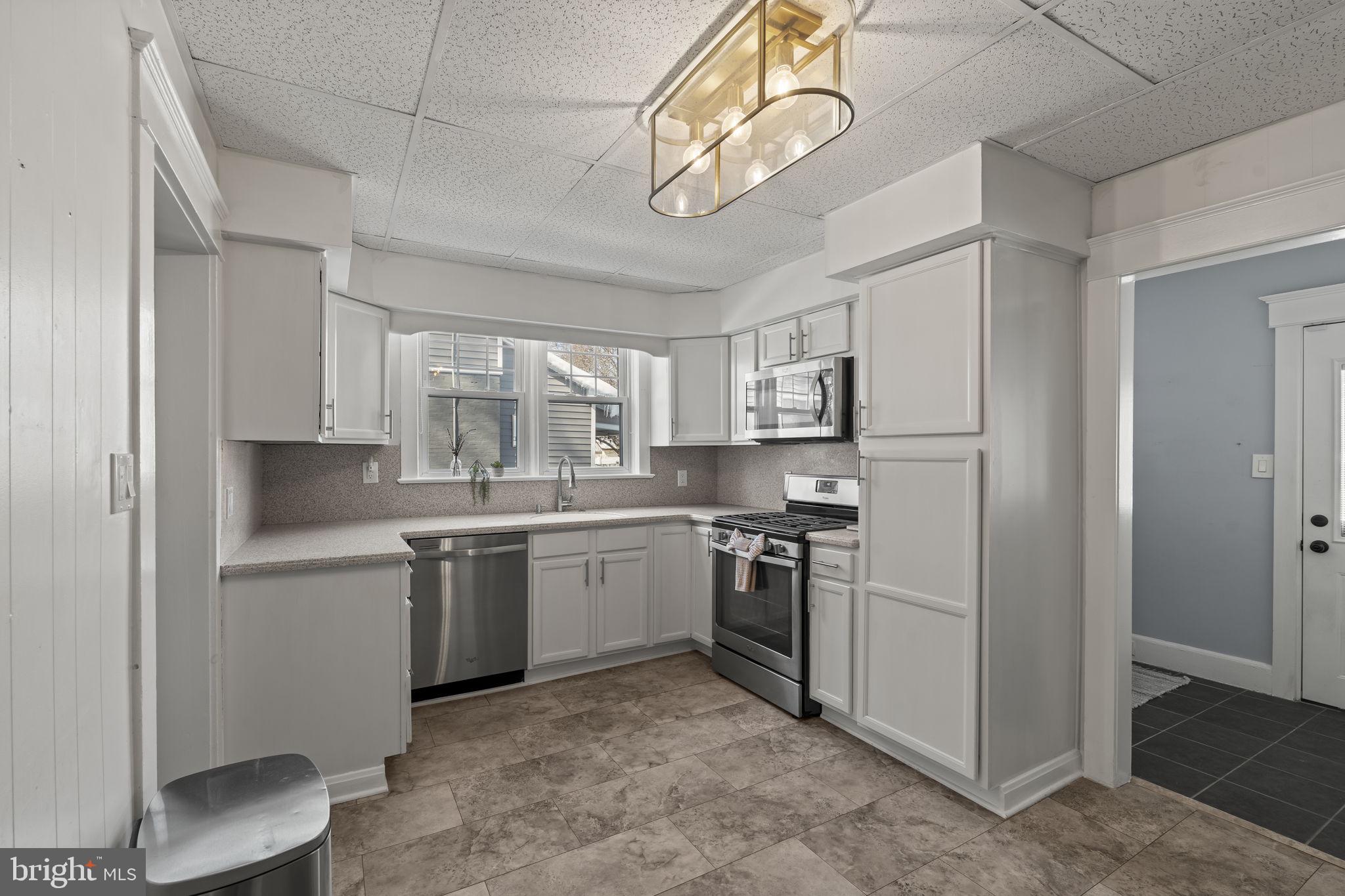 237 7th Avenue Haddon Heights, NJ 08035 - Photo 12 of 35 a kitchen with stainless steel appliances granite countertop a sink and stove top oven