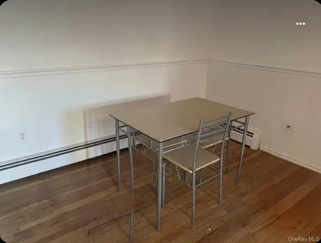 a room with wooden floor and white walls