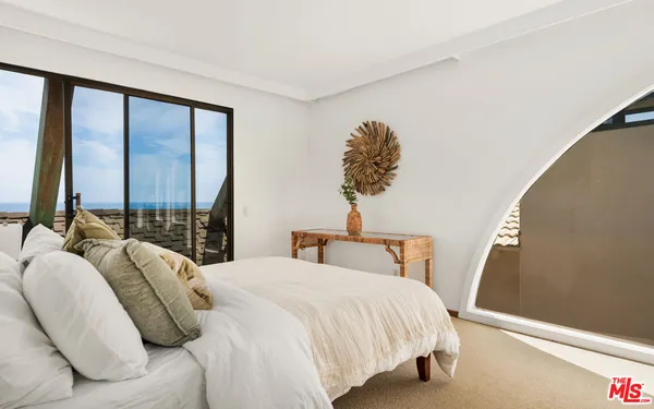 a view of a chairs and table in the balcony
