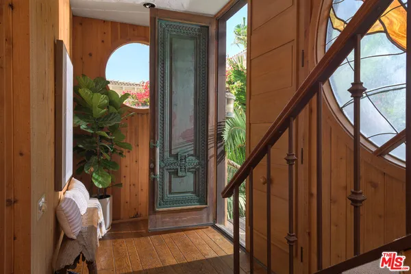 a view of living room kitchen and entryway
