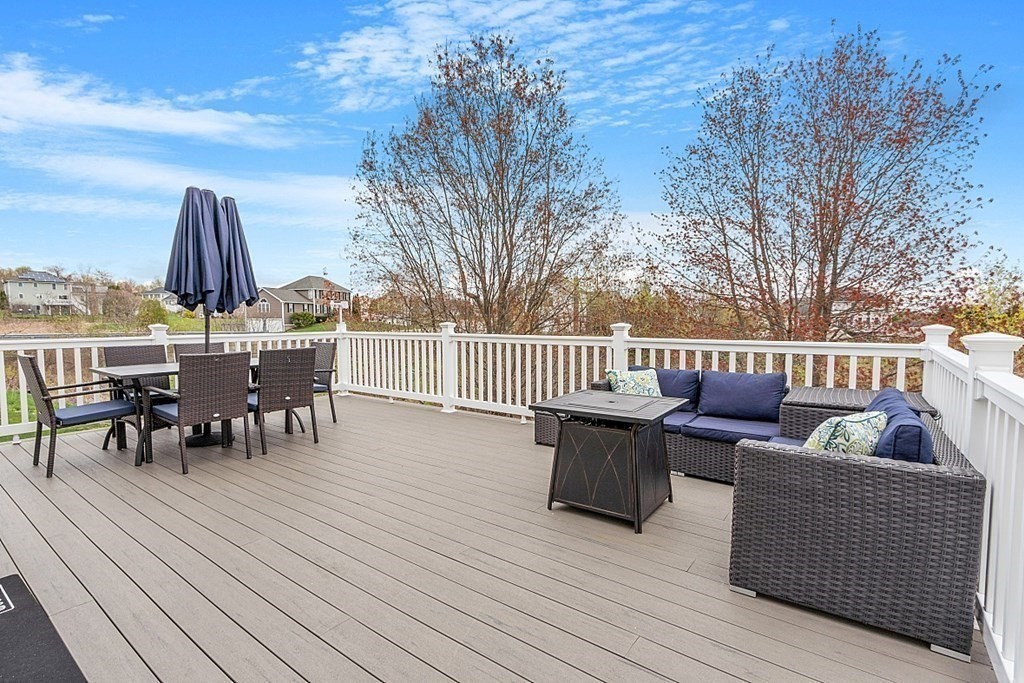 3 William Circle Rutland, MA 01543 - Photo 37 of 42 a view of a roof deck with table and chairs and wooden floor