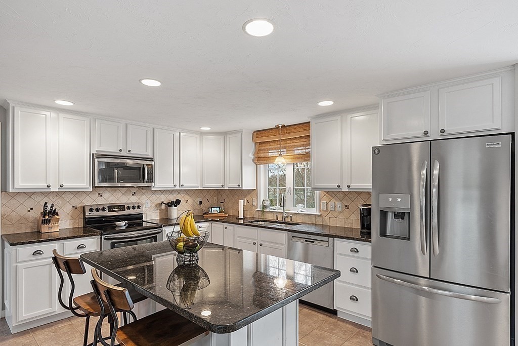 3 William Circle Rutland, MA 01543 - Photo 4 of 42 a kitchen with kitchen island granite countertop a sink a counter space stainless steel appliances and cabinets