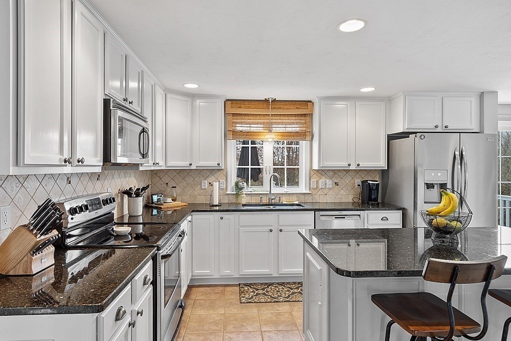3 William Circle Rutland, MA 01543 - Photo 6 of 42 a kitchen with stainless steel appliances granite countertop a sink stove refrigerator and cabinets