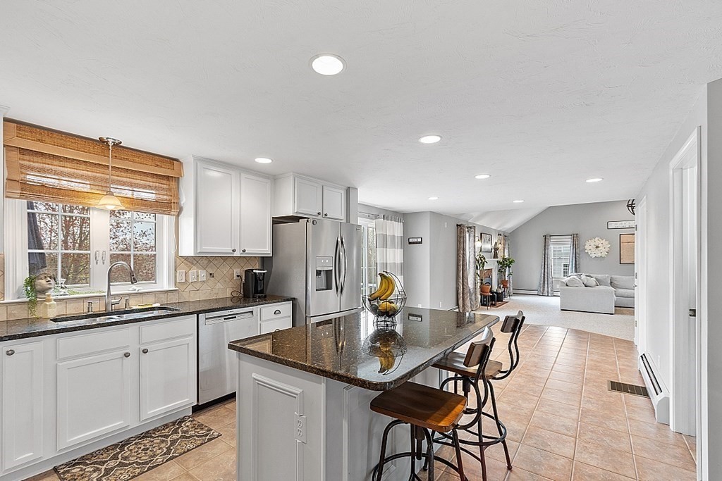 3 William Circle Rutland, MA 01543 - Photo 7 of 42 a kitchen with stainless steel appliances kitchen island granite countertop a sink and cabinets