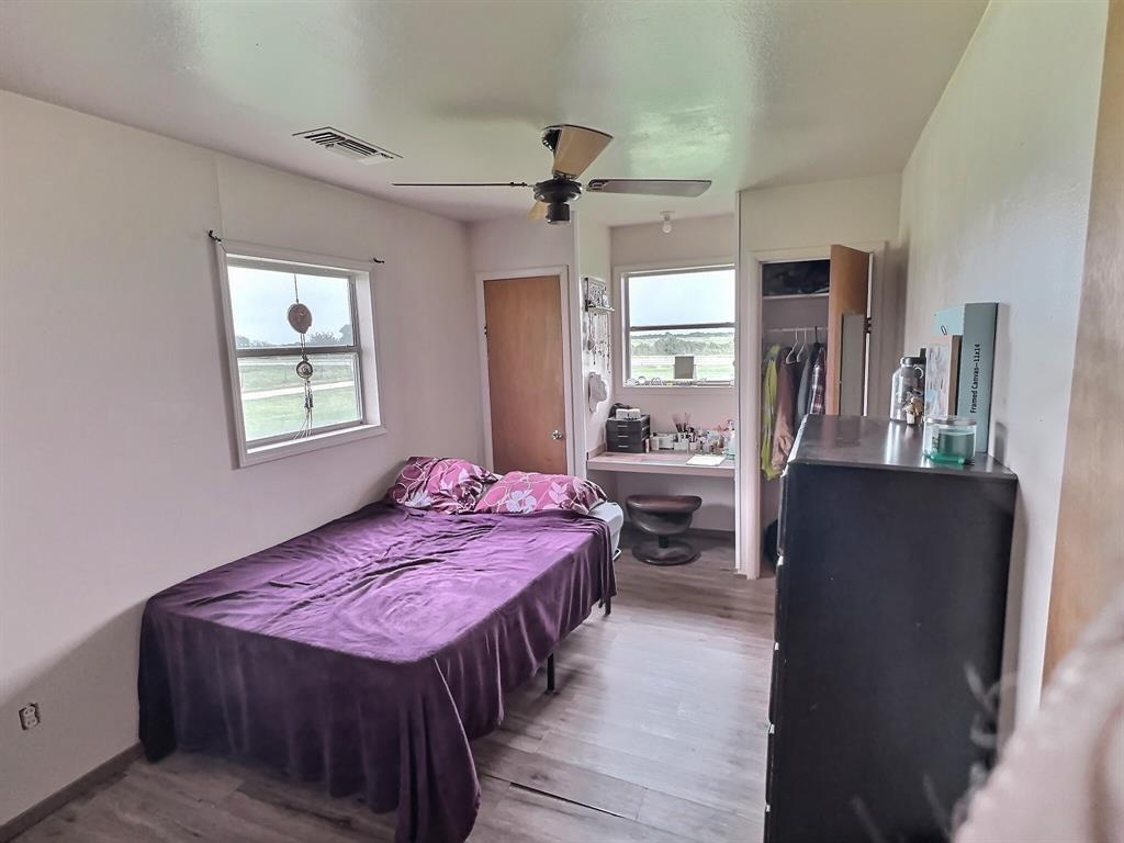 5401 Highway 36 Comanche, TX 76442 - Photo 11 of 22 a bedroom with a bed a dresser and windows