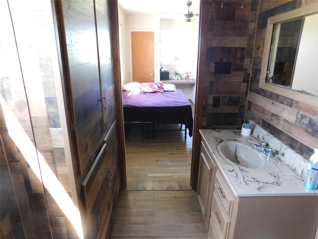 5401 Highway 36 Comanche, TX 76442 - Photo 13 of 22 a bathroom with a sink and mirror