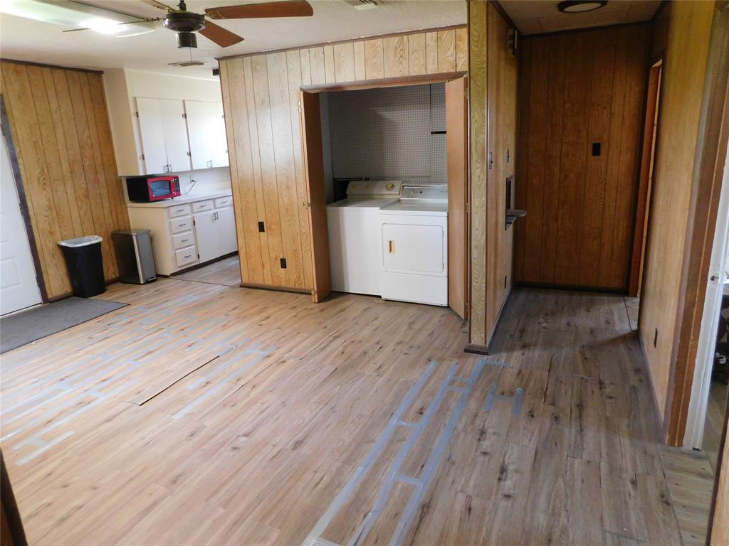 5401 Highway 36 Comanche, TX 76442 - Photo 10 of 22 wooden floor in an empty room with a fireplace