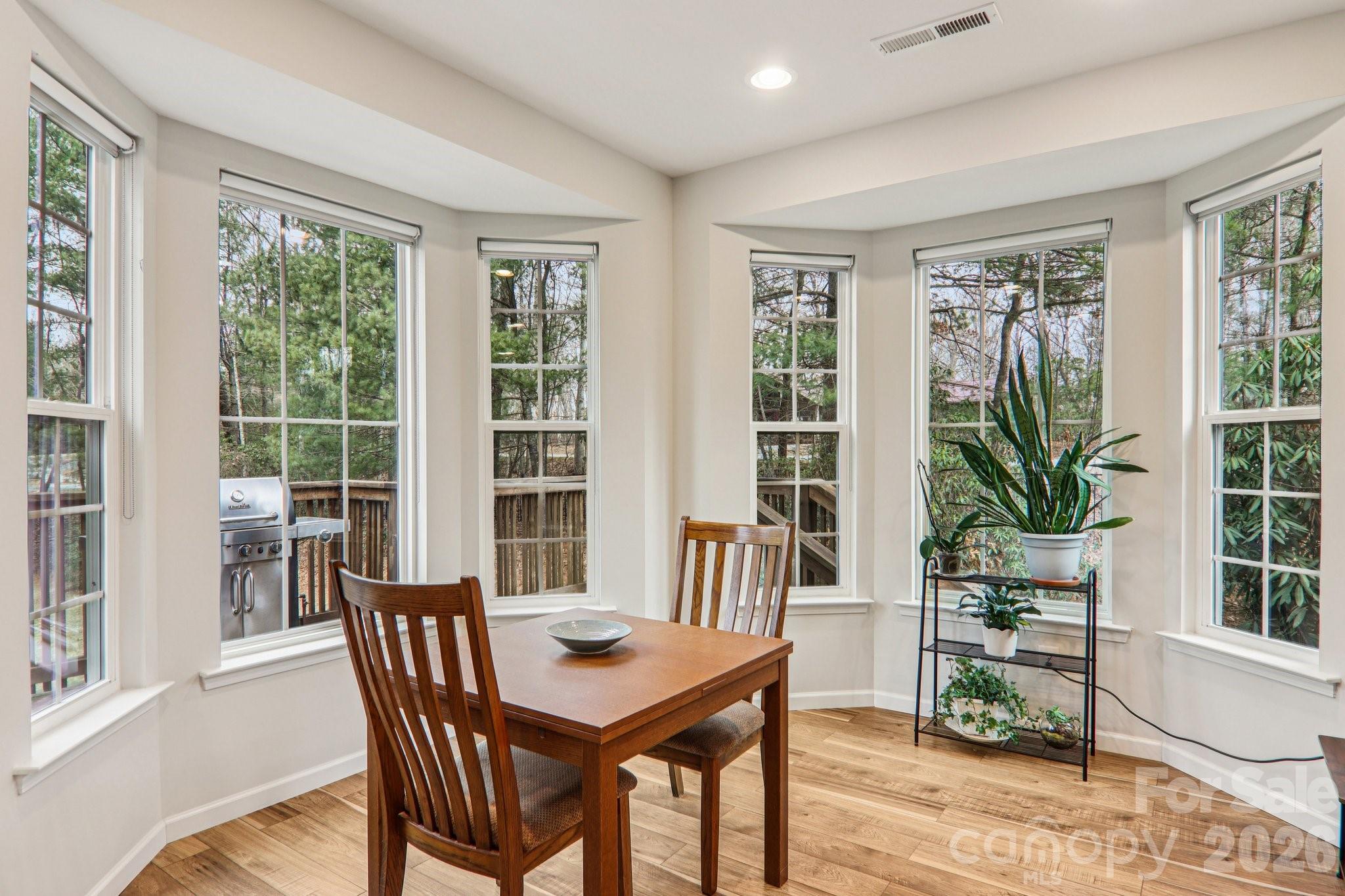29 Saddle Top Road Flat Rock, NC 28731 - Photo 13 of 46 a view of a dining room with furniture window and wooden floor