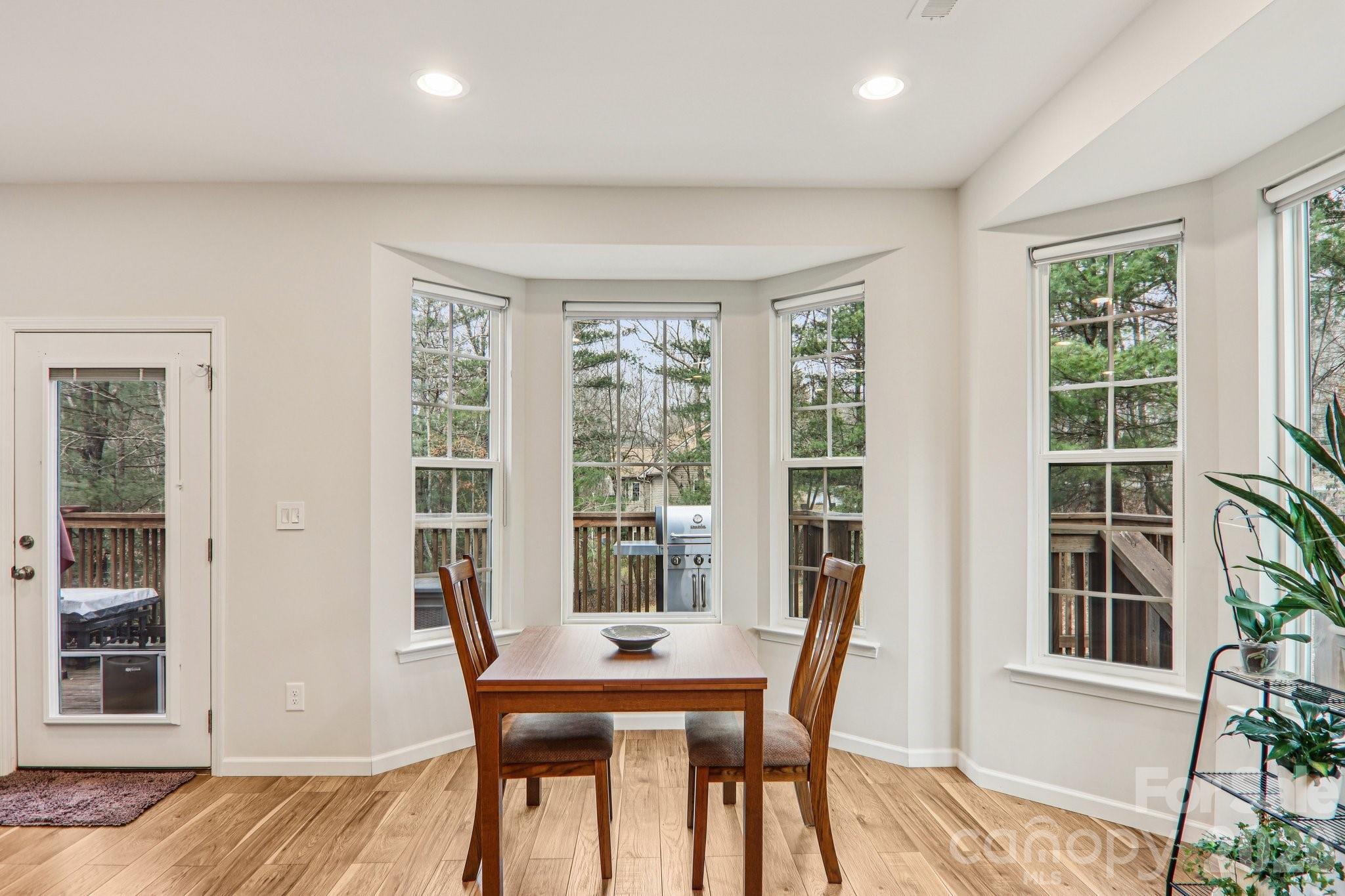 29 Saddle Top Road Flat Rock, NC 28731 - Photo 14 of 46 a view of a dining room with furniture window and wooden floor