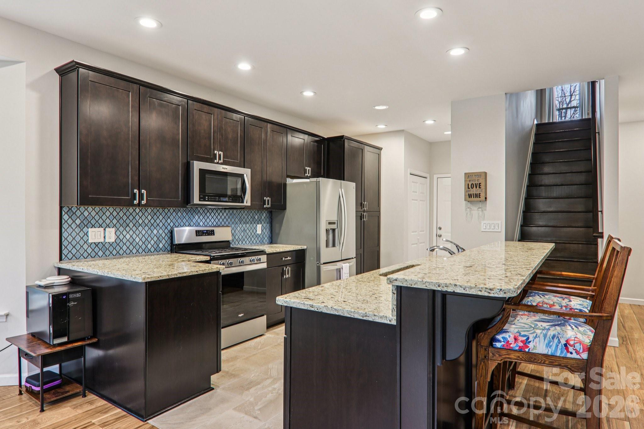 29 Saddle Top Road Flat Rock, NC 28731 - Photo 15 of 46 a open kitchen with stainless steel appliances granite countertop a stove refrigerator and cabinets