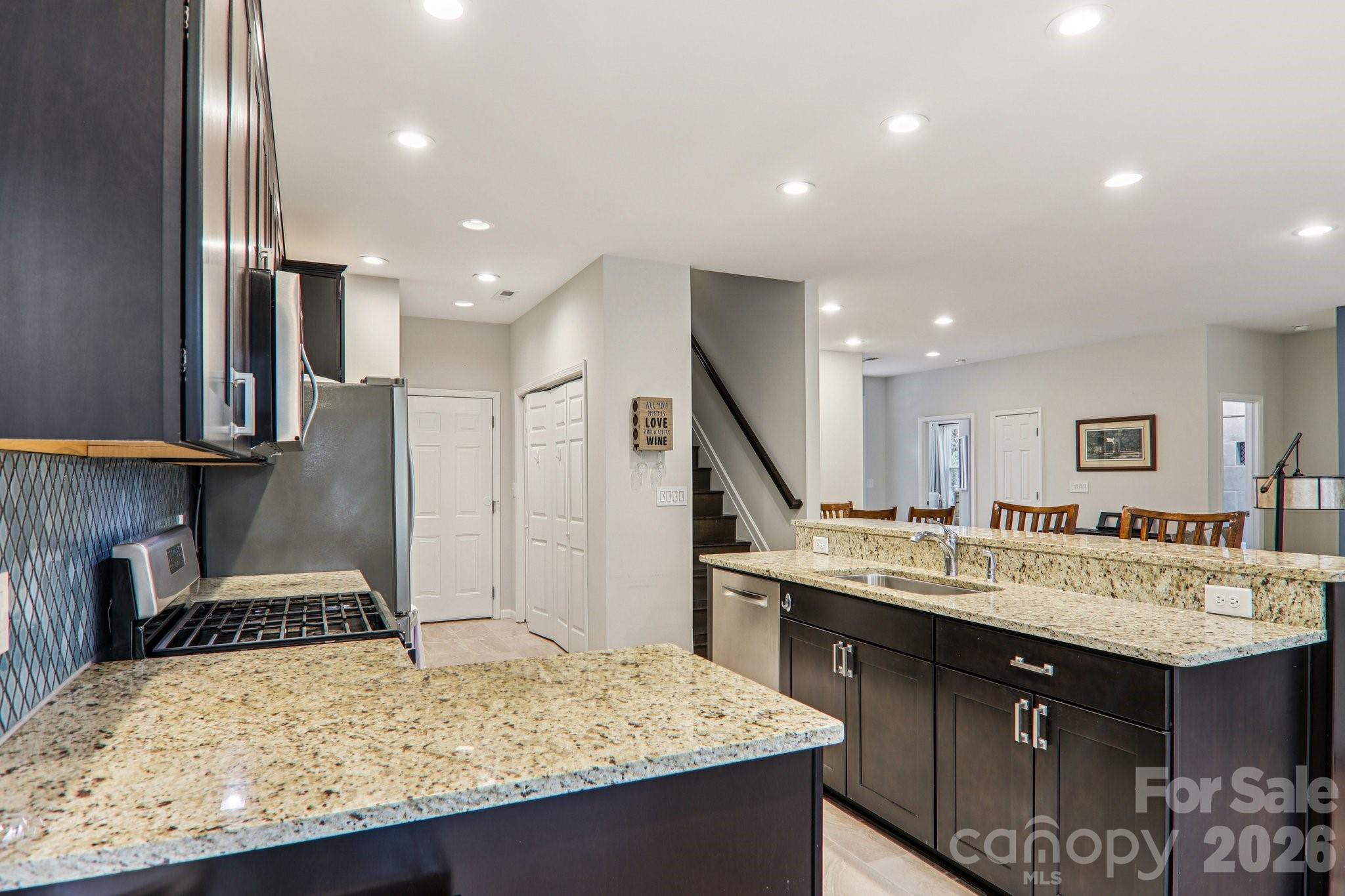 29 Saddle Top Road Flat Rock, NC 28731 - Photo 17 of 46 a kitchen with a stove a sink and a refrigerator