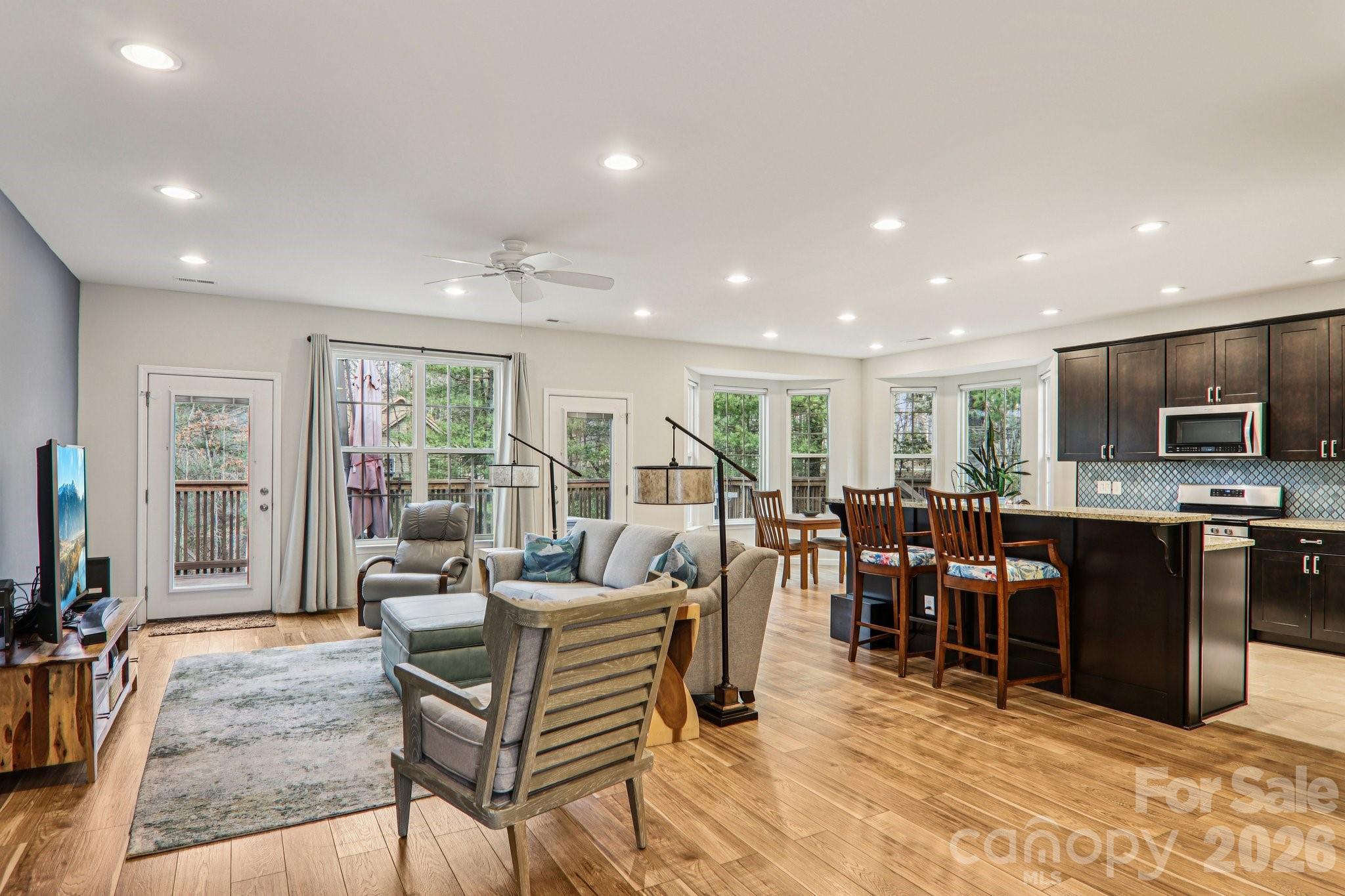29 Saddle Top Road Flat Rock, NC 28731 - Photo 2 of 46 a living room with furniture a flat screen tv and floor to ceiling window